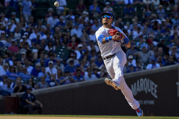Chicago Cubs shortstop Javier Baez (9) throws to first base during the ninth inning of a baseball game against the San Francisco Giants Thursday, Aug. 22, 2019, in Chicago. (AP Photo/Matt Marton)