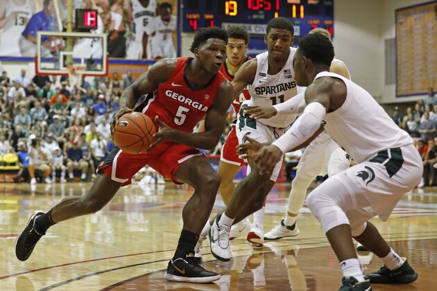 Georgia guard Anthony Edwards (5) drives into the Michigan State defense during the first half of an NCAA college basketball game Tuesday, Nov. 26, 2019, in Lahaina, Hawaii. (AP Photo/Marco Garcia)
