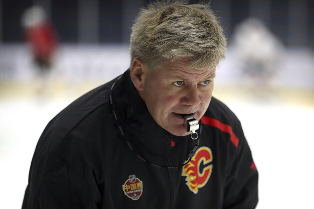 Calgary Flames head coach Bill Peters watches his team practice in Beijing, China, Monday, Sept. 17, 2018. The Flames faced off against the Boston Bruins in southern Chinese city of Shenzhen on Saturday and will play the Bruins again in Beijing on Wednesday in the 2018 NHL China Games. (AP Photo/Mark Schiefelbein)