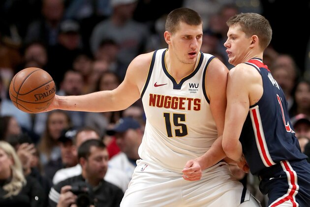 DENVER, COLORADO - NOVEMBER 26: Nikola Jokic #15 of the Denver Nuggets drives against Moritz Wagner #21 of the Washington Wizards in the first quarter at the Pepsi Center on November 26, 2019 in Denver, Colorado. NOTE TO USER: User expressly acknowledges and agrees that, by downloading and or using this photograph, User is consenting to the terms and conditions of the Getty Images License Agreement.  (Photo by Matthew Stockman/Getty Images)