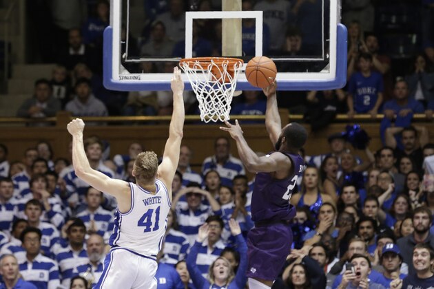 Stephen F. Austin forward Nathan Bain (23) drives for a game winning basket over Duke forward Jack White (41) during overtime in an NCAA college basketball game in Durham, N.C., Tuesday, Nov. 26, 2019. Stephen F. Austin won 85-83. (AP Photo/Gerry Broome)