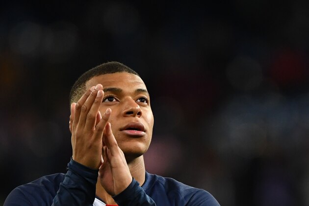 Paris Saint-Germain's French forward Kylian Mbappe applauds at the end of the UEFA Champions League group A football match Real Madrid against Paris Saint-Germain FC at the Santiago Bernabeu stadium in Madrid on November 26, 2019. (Photo by GABRIEL BOUYS / AFP) (Photo by GABRIEL BOUYS/AFP via Getty Images)