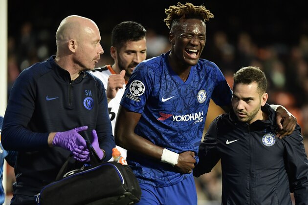 Chelsea's English striker Tammy Abraham is helped after resulting injured during the UEFA Champions League Group H football match between Valencia CF and Chelsea FC at the Mestalla stadium in Valencia on November 27, 2019. (Photo by JAVIER SORIANO / AFP) (Photo by JAVIER SORIANO/AFP via Getty Images)