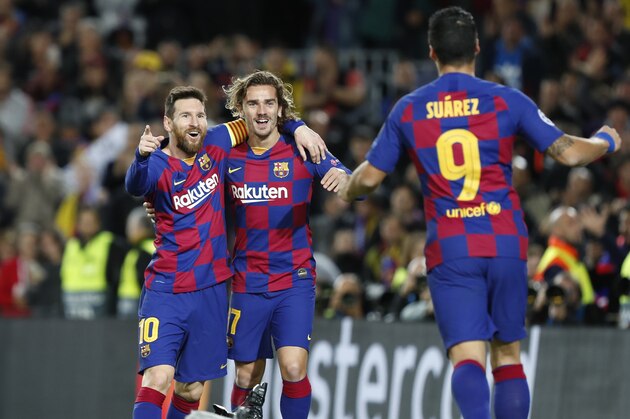 Barcelona's Lionel Messi, left, celebrates after scoring his side's second goal with Antoine Griezmann, centre and Luis Suarez during a Champions League soccer match Group F between Barcelona and Dortmund at the Camp Nou stadium in Barcelona, Spain, Wednesday, Nov. 27, 2019. (AP Photo/Joan Monfort)