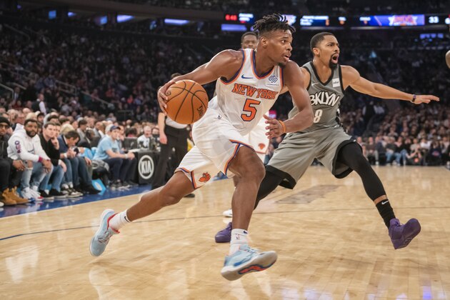 New York Knicks guard Dennis Smith Jr. (5) drives against Brooklyn Nets guard Spencer Dinwiddie (8) in the first half of an NBA basketball game, Sunday, Nov. 24, 2019, at Madison Square Garden in New York. The Nets win 103-101. (AP Photo/Corey Sipkin).