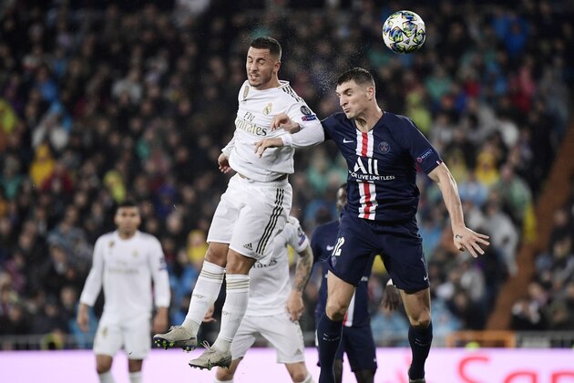 Real Madrid's Belgian forward Eden Hazard (L) vies with Paris Saint-Germain's Belgian defender Thomas Meunier during the UEFA Champions League group A football match against Paris Saint-Germain FC at the Santiago Bernabeu stadium in Madrid on November 26, 2019. (Photo by JAVIER SORIANO / AFP) (Photo by JAVIER SORIANO/AFP via Getty Images)