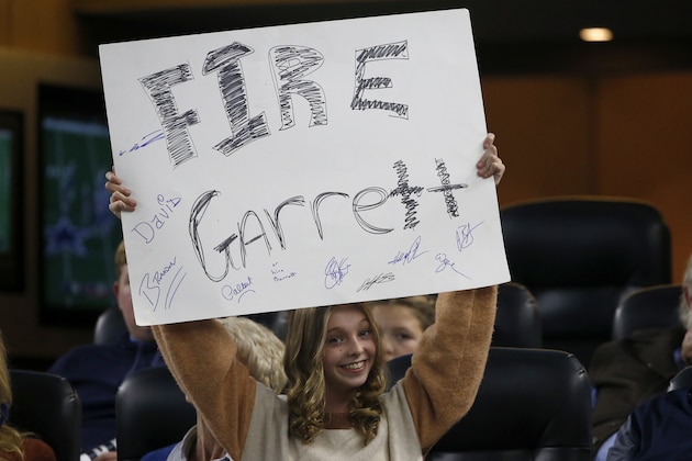 A young fan holds a sign calling for the firing of Dallas Cowboys head coach Jason Garrett in the second half of an NFL football game against the Buffalo Bills in Arlington, Texas, Thursday, Nov. 28, 2019. (AP Photo/Ron Jenkins)