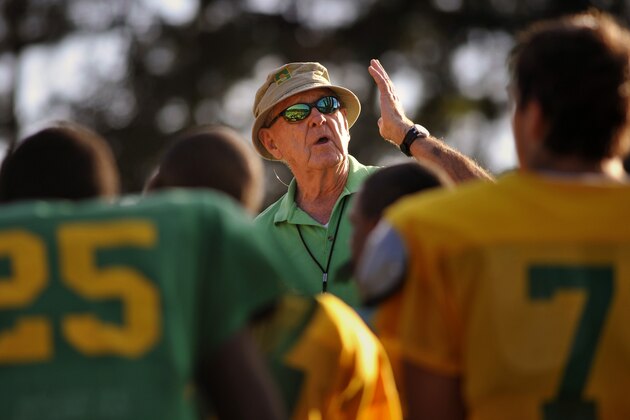 FILE - In this Oct. 24, 2012, file photo, Summerville High School coach John McKissick coaches his team during practice in Summerville, S.C. McKissick, whose 621 victories at South Carolina’s Summerville High made him the nation’s winningest football coach at any level, has died at age 93. Dorchester County Coroner Paul Brouthers said McKissick had been in hospice care and died Thursday, Nov. 28, 2019, surrounded by family. (AP Photo/Stephen Morton, File)