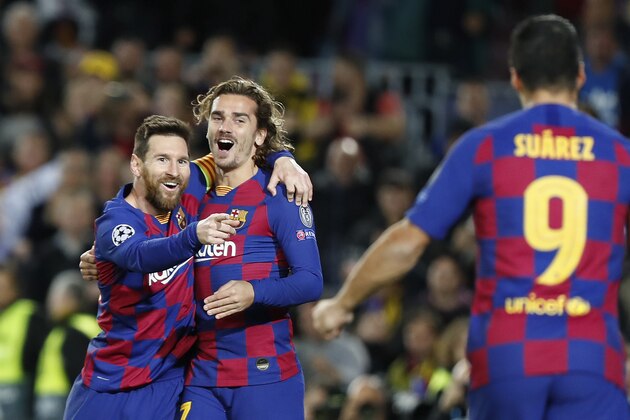 Barcelona's Lionel Messi, left, celebrates after scoring his side's second goal with Antoine Griezmann, centre and Luis Suarez during a Champions League soccer match Group F between Barcelona and Dortmund at the Camp Nou stadium in Barcelona, Spain, Wednesday, Nov. 27, 2019. (AP Photo/Joan Monfort)