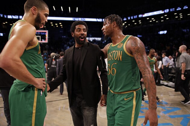 Brooklyn Nets guard Kyrie Irving greets Boston Celtics guard Marcus Smart (36) and forward Jayson Tatum after their NBA basketball game Friday, Nov. 29, 2019, in New York. The Nets won 112-107. (AP Photo/Adam Hunger)