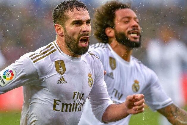 Real Madrid's Spanish defender Daniel Carvajal (L) celebrates after scoring a goal during the Spanish league football match between Deportivo Alaves and Real Madrid CF at the Mendizorroza stadium in Vitoria on November 30, 2019. (Photo by ANDER GILLENEA / AFP) (Photo by ANDER GILLENEA/AFP via Getty Images)
