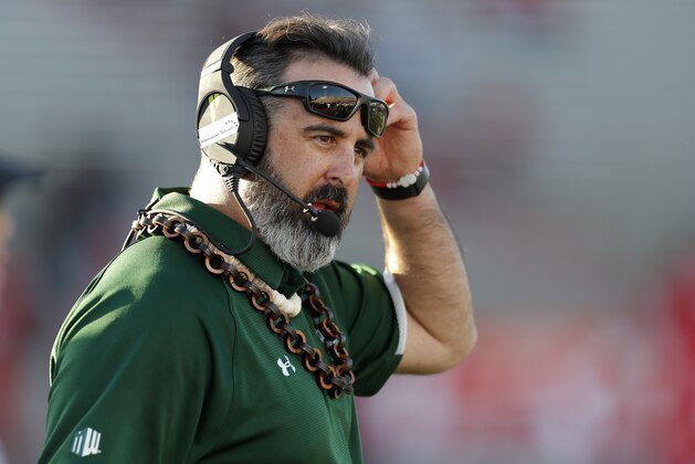 Hawaii coach Nick Rolovich speaks through his headset during a timeout in the second half of an NCAA college football game against New Mexico, Saturday, Oct. 26, 2019, in Albuquerque, N.M. (AP Photo/Andres Leighton)