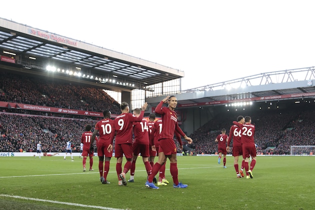 Liverpool's Virgil van Dijk centre right celebrates after scoring his second goal during the English Premier League soccer match between Liverpool and Brighton at Anfield Stadium, Liverpool, England, Saturday, Nov. 30, 2019. (AP Photo/Jon Super)