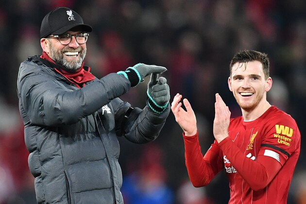 Liverpool's German manager Jurgen Klopp (L) and Liverpool's Scottish defender Andrew Robertson applaud the fans following the English Premier League football match between Liverpool and Brighton and Hove Albion at Anfield in Liverpool, north west England on January 1, 2019. - Liverpool won the match 2-1. (Photo by Paul ELLIS / AFP) / RESTRICTED TO EDITORIAL USE. No use with unauthorized audio, video, data, fixture lists, club/league logos or 'live' services. Online in-match use limited to 120 images. An additional 40 images may be used in extra time. No video emulation. Social media in-match use limited to 120 images. An additional 40 images may be used in extra time. No use in betting publications, games or single club/league/player publications. /  (Photo by PAUL ELLIS/AFP via Getty Images)