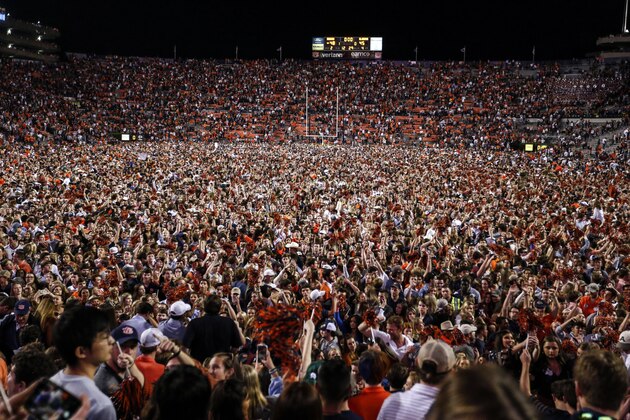 Auburn fans storm the field after they defeated Alabama 48-45 in an NCAA college football game Saturday, Nov. 30, 2019, in Auburn, Ala. (AP Photo/Butch Dill)