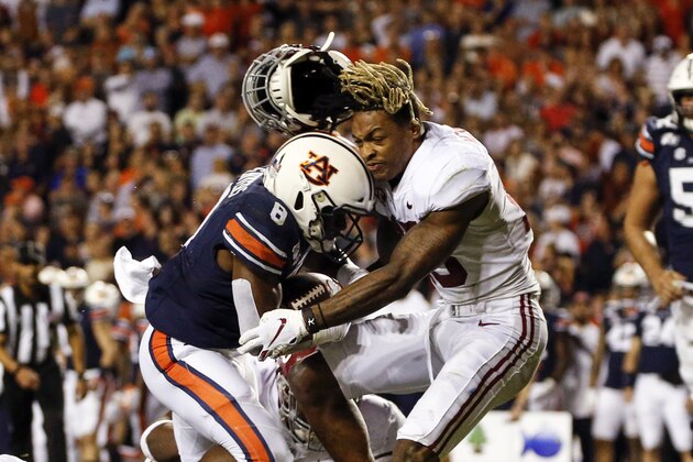 Alabama defensive back Xavier McKinney (15) loses his helmet as Auburn running back Shaun Shivers (8) runs through him for a touchdown during the second half of an NCAA college football game Saturday, Nov. 30, 2019, in Auburn, Ala. (AP Photo/Butch Dill) Alabama defensive back Xavier McKinney (15) loses his helmet as Auburn running back Shaun Shivers (8) runs through him for a touchdown during the second half of an NCAA college football game Saturday, Nov. 30, 2019, in Auburn, Ala. (AP Photo/Butch Dill)