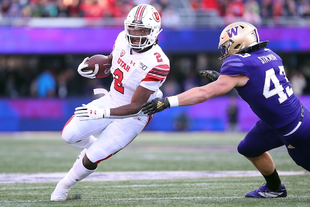SEATTLE, WASHINGTON - NOVEMBER 02: Zack Moss #2 of the Utah Utes runs with the ball against Jackson Sirmon #43 of the Washington Huskies in the second quarter during their game at Husky Stadium on November 02, 2019 in Seattle, Washington. (Photo by Abbie Parr/Getty Images)