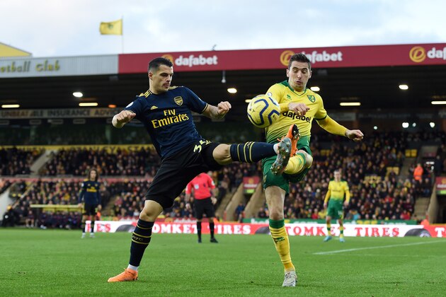 NORWICH, ENGLAND - DECEMBER 01: Granit Xhaka of Arsenal battles for possession with Kenny Mclean of Norwich City during the Premier League match between Norwich City and Arsenal FC at Carrow Road on December 01, 2019 in Norwich, United Kingdom. (Photo by Harriet Lander/Copa/Getty Images)