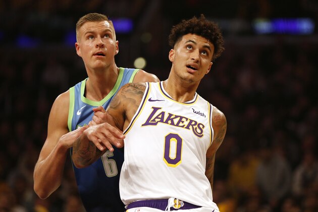LOS ANGELES, CALIFORNIA - DECEMBER 01:  Kyle Kuzma #0 of the Los Angeles Lakers defends Kristaps Porzingis #6 of the Dallas Mavericks during a game at Staples Center on December 01, 2019 in Los Angeles, California. NOTE TO USER: User expressly acknowledges and agrees that, by downloading and or using this photograph, User is consenting to the terms and conditions of the Getty Images License Agreement. (Photo by Katharine Lotze/Getty Images)