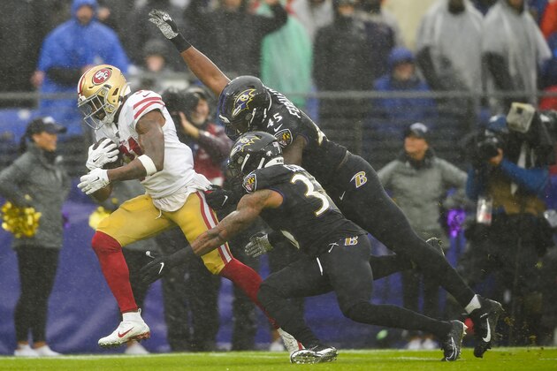 San Francisco 49ers running back Raheem Mostert (31) scores a touchdown against Baltimore Ravens defensive back Chuck Clark (36) and linebacker Jaylon Ferguson (45) in the first half of an NFL football game, Sunday, Dec. 1, 2019, in Baltimore, Md. (AP Photo/Gail Burton)