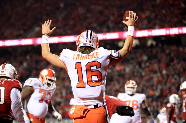 RALEIGH, NORTH CAROLINA - NOVEMBER 09: Trevor Lawrence #16 of the Clemson Tigers reacts after scoring a touchdown against the North Carolina State Wolfpack during their game at Carter-Finley Stadium on November 09, 2019 in Raleigh, North Carolina. (Photo by Streeter Lecka/Getty Images)