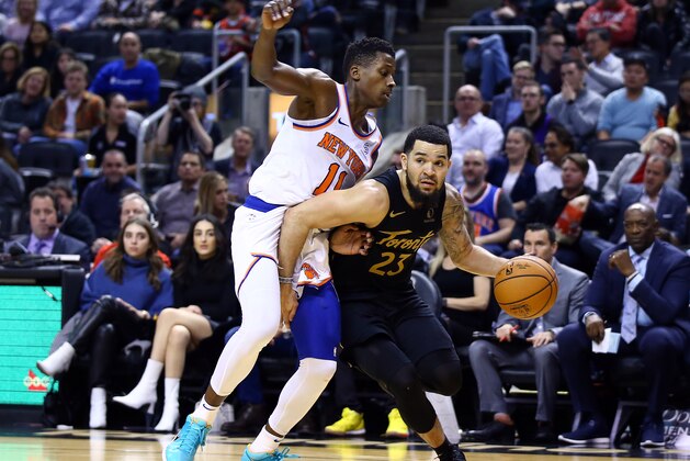 TORONTO, ON - NOVEMBER 27:  Fred VanVleet #23 of the Toronto Raptors dribbles the ball as Frank Ntilikina #11 of the New York Knicks defends during the second half of an NBA game at Scotiabank Arena on November 27, 2019 in Toronto, Canada.  NOTE TO USER: User expressly acknowledges and agrees that, by downloading and or using this photograph, User is consenting to the terms and conditions of the Getty Images License Agreement.  (Photo by Vaughn Ridley/Getty Images)