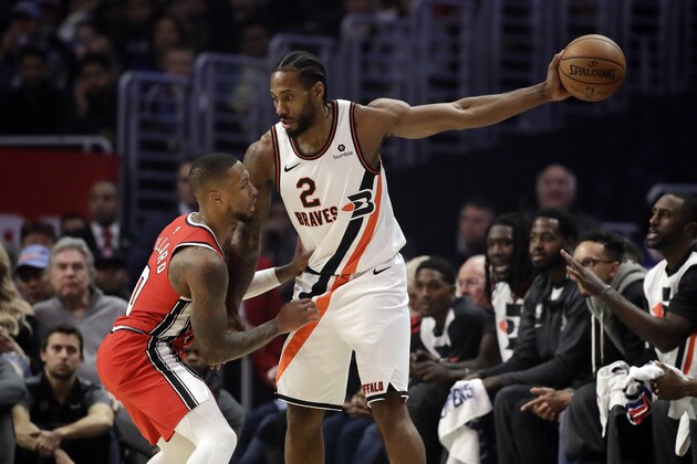 Portland Trail Blazers' Damian Lillard, left, defends on Los Angeles Clippers' Kawhi Leonard (2) during the first half of an NBA basketball game Tuesday, Dec. 3, 2019, in Los Angeles. (AP Photo/Marcio Jose Sanchez)