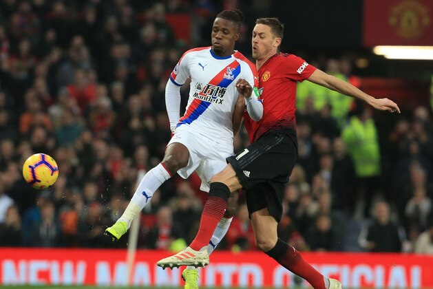 Crystal Palace's Ivorian striker Wilfried Zaha (L) vies with Manchester United's Serbian midfielder Nemanja Matic (R) during the English Premier League football match between Manchester United and Crystal Palace at Old Trafford in Manchester, north west England, on November 24, 2018. (Photo by Lindsey PARNABY / AFP) / RESTRICTED TO EDITORIAL USE. No use with unauthorized audio, video, data, fixture lists, club/league logos or 'live' services. Online in-match use limited to 120 images. An additional 40 images may be used in extra time. No video emulation. Social media in-match use limited to 120 images. An additional 40 images may be used in extra time. No use in betting publications, games or single club/league/player publications. /         (Photo credit should read LINDSEY PARNABY/AFP via Getty Images)