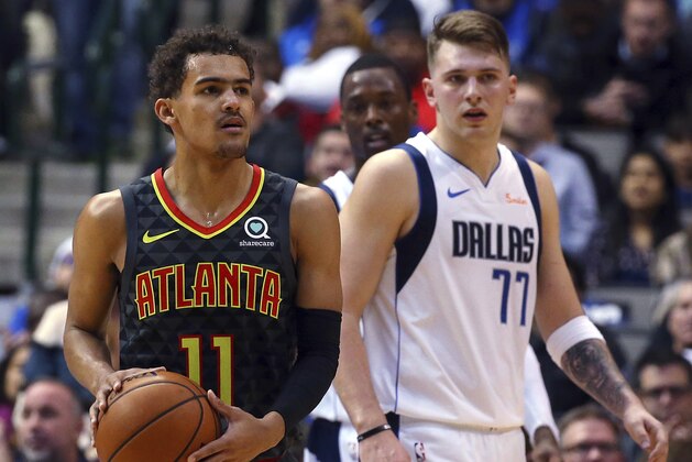 Atlanta Hawks guard Trae Young (11) and Dallas Mavericks forward Luka Doncic (77) stand on the court during the second half of an NBA basketball game Wednesday, Dec. 12, 2018, in Dallas. (AP Photo/Richard W. Rodriguez)