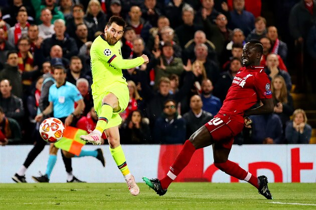 LIVERPOOL, ENGLAND - MAY 07: Lionel Messi of FC Barcelona is challenged by Sadio Mane of Liverpool as he takes a shot during the UEFA Champions League Semi Final second leg match between Liverpool and Barcelona at Anfield on May 07, 2019 in Liverpool, England. (Photo by Chris Brunskill/Fantasista/Getty Images)