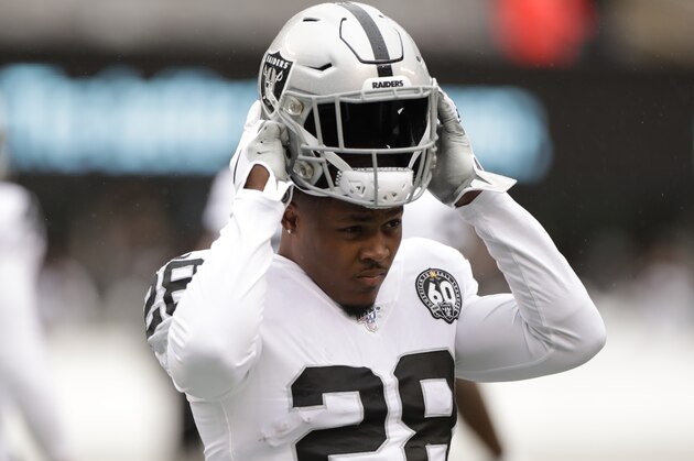 Oakland Raiders running back Josh Jacobs (28) puts on his helmet as he warms up before an NFL football game against the New York Jets Sunday, Nov. 24, 2019, in East Rutherford, N.J. (AP Photo/Adam Hunger)