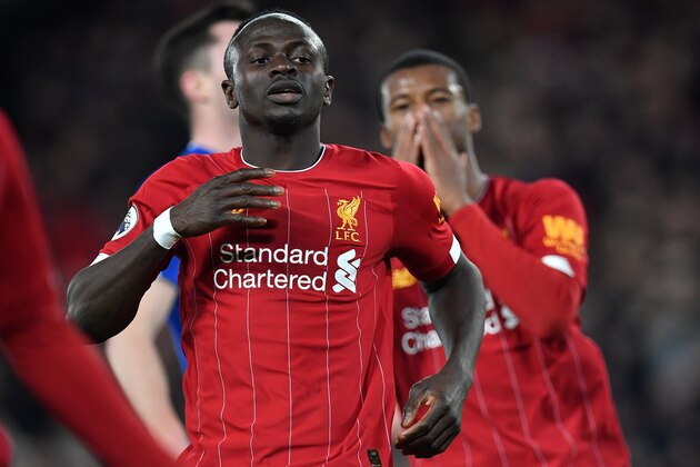 Liverpool's Senegalese striker Sadio Mane (L) reacts after failing to score during the English Premier League football match between Liverpool and Everton at Anfield in Liverpool, north west England on December 4, 2019. (Photo by Paul ELLIS / AFP) / RESTRICTED TO EDITORIAL USE. No use with unauthorized audio, video, data, fixture lists, club/league logos or 'live' services. Online in-match use limited to 120 images. An additional 40 images may be used in extra time. No video emulation. Social media in-match use limited to 120 images. An additional 40 images may be used in extra time. No use in betting publications, games or single club/league/player publications. /  (Photo by PAUL ELLIS/AFP via Getty Images)