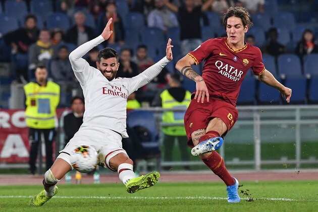 AS Roma's Italian midfielder Nicolo Zaniolo (R) kicks the ball past AC Milan's Italian defender Mateo Musacchio during the Italian Serie A football match between AS Roma and AC Milan at the Olympic stadium in Rome on October 27, 2019. (Photo by Andreas SOLARO / AFP) (Photo by ANDREAS SOLARO/AFP via Getty Images)