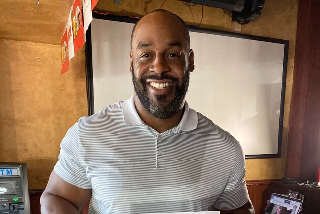 SYRACUSE, NY - SEPTEMBER 15:  Former Syracuse Orange quarterback Donovan McNabb jokes with former teammates on the sideline during the game between the Syracuse Orange and the Florida State Seminoles at the Carrier Dome on September 15, 2018 in Syracuse, New York. Syracuse defeats Florida State 30-7. (Photo by Brett Carlsen/Getty Images)
