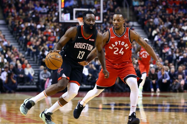 TORONTO, ON - DECEMBER 05:  James Harden #13 of the Houston Rockets dribbles the ball as Norman Powell #24 of the Toronto Raptors defends during the first half of an NBA game at Scotiabank Arena on December 05, 2019 in Toronto, Canada.  NOTE TO USER: User expressly acknowledges and agrees that, by downloading and or using this photograph, User is consenting to the terms and conditions of the Getty Images License Agreement.  (Photo by Vaughn Ridley/Getty Images)