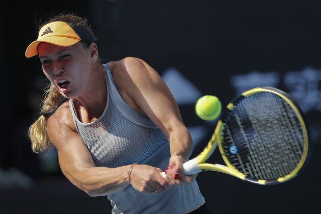 Caroline Wozniacki of Denmark hits a return shot against Katerina Siniakova of the Czech Republic during their third round of the women's singles match in the China Open tennis tournament at the Diamond Court in Beijing, Thursday, Oct. 3, 2019. (AP Photo/Andy Wong) Caroline Wozniacki of Denmark hits a return shot against Katerina Siniakova of the Czech Republic during their third round of the women's singles match in the China Open tennis tournament at the Diamond Court in Beijing, Thursday, Oct. 3, 2019. (AP Photo/Andy Wong)