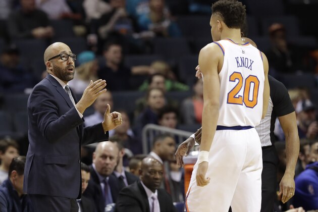 New York Knicks head coach David Fizdale, left, talks with Kevin Knox (20) during the first half of an NBA basketball game against the Charlotte Hornets in Charlotte, N.C., Monday, Jan. 28, 2019. (AP Photo/Chuck Burton)