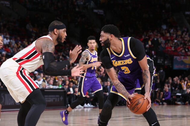 PORTLAND, OR - DECEMBER 6: Anthony Davis #3 of the Los Angeles Lakers handles the ball against Carmelo Anthony #00 of the Portland Trail Blazers on December 6, 2019 at the Moda Center Arena in Portland, Oregon. NOTE TO USER: User expressly acknowledges and agrees that, by downloading and or using this photograph, user is consenting to the terms and conditions of the Getty Images License Agreement. Mandatory Copyright Notice: Copyright 2019 NBAE (Photo by Sam Forencich/NBAE via Getty Images)