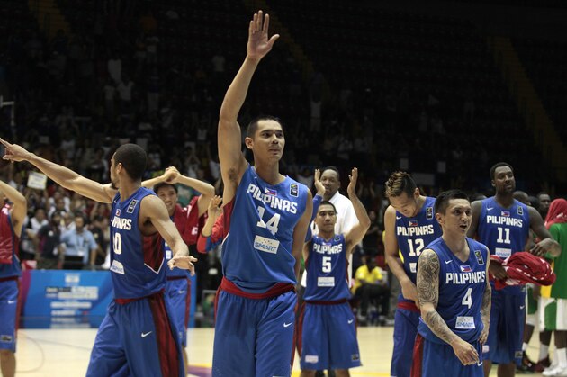 Japeth Aguilar of the Philippines, center, waves with teammates after winning the Group B Basketball World Cup match against Senegal in Seville, Spain, Thursday, Sept. 4, 2014. The 2014 Basketball World Cup competition will take place in various cities in Spain from Aug. 30 through to Sept. 14. (AP Photo/Miguel Angel Morenatti)