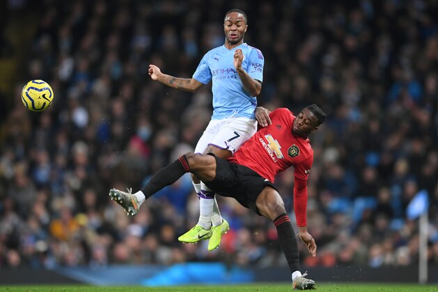 MANCHESTER, ENGLAND - DECEMBER 07: Raheem Sterling of Manchester City collides with Aaron Wan-Bissaka of Manchester United  during the Premier League match between Manchester City and Manchester United at Etihad Stadium on December 07, 2019 in Manchester, United Kingdom. (Photo by Laurence Griffiths/Getty Images)