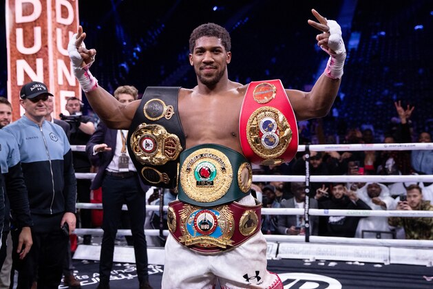 DIRIYAH, SAUDI ARABIA - DECEMBER 07:  Anthony Joshua poses for a photo with the IBF, WBA, WBO & IBO World Heavyweight Title belts after the IBF, WBA, WBO & IBO World Heavyweight Title Fight between Andy Ruiz Jr and Anthony Joshua during the Matchroom Boxing 'Clash on the Dunes' show at the Diriyah Season on December 07, 2019 in Diriyah, Saudi Arabia (Photo by Richard Heathcote/Getty Images)