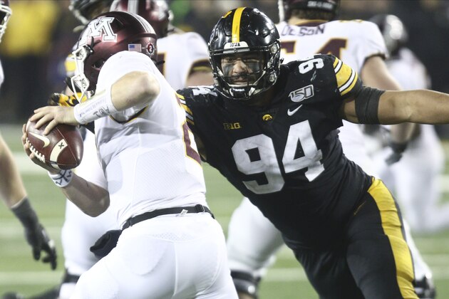 IOWA CITY, IOWA- NOVEMBER 16:  Defensive end A.J. Epenesa #94 of the Iowa Hawkeyesputs pressure during the second half on quarterback Tanner Morgan #2 of the Minnesota Gophers on November 16, 2019 at Kinnick Stadium in Iowa City, Iowa.  (Photo by Matthew Holst/Getty Images)