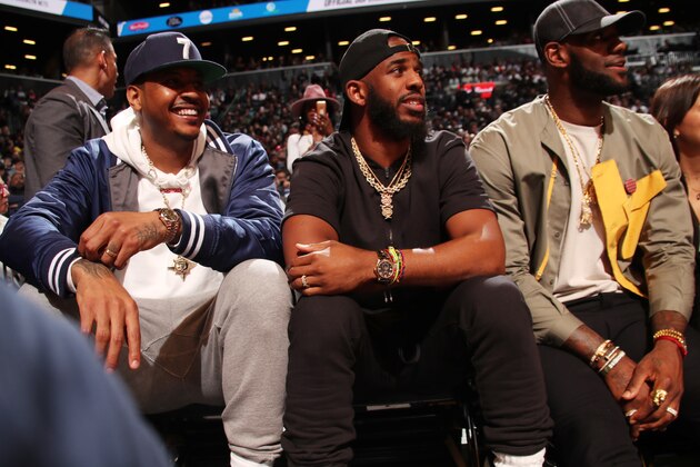 BROOKLYN, NY - APRIL 10: Carmelo Anthony, Chris Paul #3 of the Houston Rockets, and LeBron James #23 of the Los Angeles Lakers look on during a game between the Miami Heat and the Brooklyn Nets on April 10, 2019 at Barclays Center in Brooklyn, New York. NOTE TO USER: User expressly acknowledges and agrees that, by downloading and or using this Photograph, user is consenting to the terms and conditions of the Getty Images License Agreement. Mandatory Copyright Notice: Copyright 2019 NBAE (Photo by Issac Baldizon/NBAE via Getty Images)