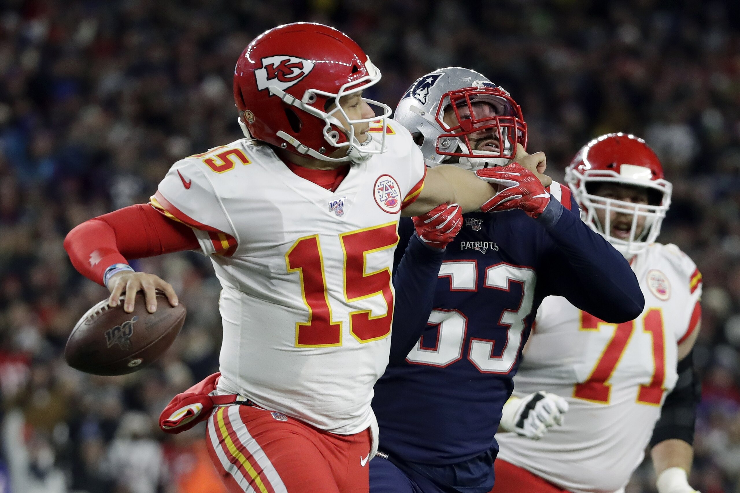 Kansas City Chiefs quarterback Patrick Mahomes grabs the face mask of New England Patriots linebacker Kyle Van Noy, right, as he rolls out to pass in the second half of an NFL football game, Sunday, Dec. 8, 2019, in Foxborough, Mass. Mahomes was penalized on the play. (AP Photo/Elise Amendola) Kansas City Chiefs quarterback Patrick Mahomes grabs the face mask of New England Patriots linebacker Kyle Van Noy, right, as he rolls out to pass in the second half of an NFL football game, Sunday, Dec. 8, 2019, in Foxborough, Mass. Mahomes was penalized on the play. (AP Photo/Elise Amendola)