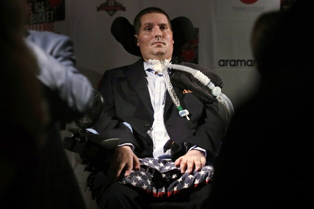 FILE -In this Sept. 18, 2017 photograph, Pete Frates, who is stricken with amyotrophic lateral sclerosis, or ALS, listens to a guest at Fenway Park in Boston. On Thursday, June 27, 2019, Boston College unveiled plans for the Pete Frates Center, a new indoor baseball and softball training facility that will be named after the alumnus who helped popularize the ice bucket challenge. (AP Photo/Charles Krupa, File)