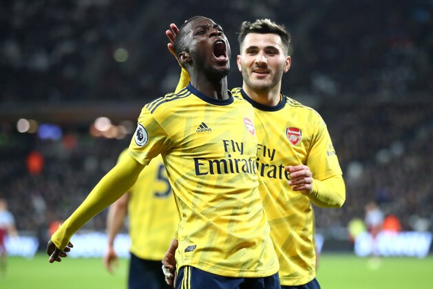 LONDON, ENGLAND - DECEMBER 09: Nicolas Pepe of Arsenal celebrates after scoring his sides second goal with Saed Kolasinac during the Premier League match between West Ham United and Arsenal FC at London Stadium on December 09, 2019 in London, United Kingdom. (Photo by Julian Finney/Getty Images)