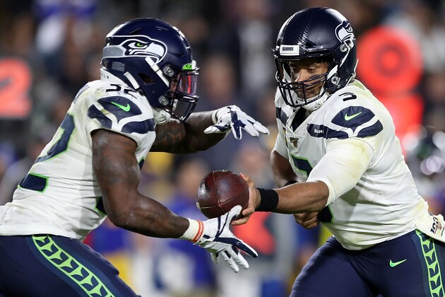 LOS ANGELES, CALIFORNIA - DECEMBER 08: Quarterback Russell Wilson #3 of the Seattle Seahawks  hands off to running back Chris Carson #32 during the game against the Los Angeles Rams at Los Angeles Memorial Coliseum on December 08, 2019 in Los Angeles, California. (Photo by Meg Oliphant/Getty Images)