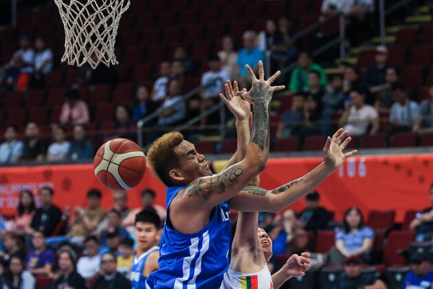 MANILA, PHILIPPINES - DECEMBER 07: Vic Manuel #4 of the Philippines battles for the ball against Chin Ta #4 of Myanmar during the 5x5 Men's Basketball at the Mall of Asia Arena during day 7 of the Southeast Asian Games on December 07, 2019 in Manila, Philippines. (Photo by Annice Lyn/Getty Images)
