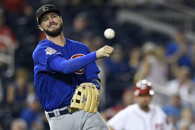 Chicago Cubs third baseman Kris Bryant throws to first to get out Washington Nationals' Howie Kendrick during the ninth inning of a baseball game, Sunday, May 19, 2019, in Washington. The Cubs won 6-5. (AP Photo/Nick Wass)