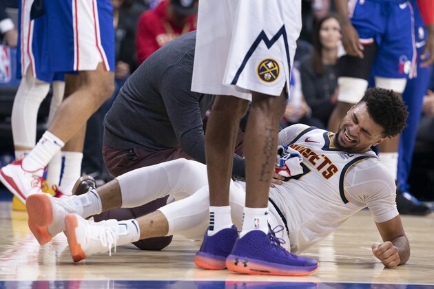 PHILADELPHIA, PA - DECEMBER 10: Jamal Murray #27 of the Denver Nuggets reacts after an injury in the first quarter against the Philadelphia 76ers at the Wells Fargo Center on December 10, 2019 in Philadelphia, Pennsylvania. NOTE TO USER: User expressly acknowledges and agrees that, by downloading and/or using this photograph, user is consenting to the terms and conditions of the Getty Images License Agreement. (Photo by Mitchell Leff/Getty Images)